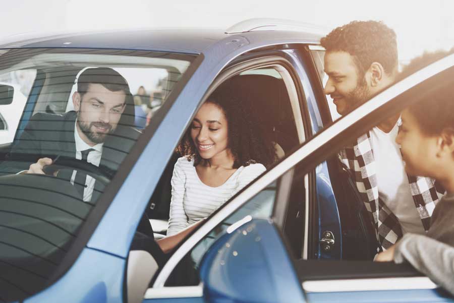 Man and woman test drive before they buy a car.